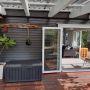 Installation of new double glazed aluminium bi-fold door providing a new wide access to outdoor deck area.
