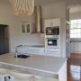 New kitchen with tiled splashback and pantry in behind kitchen