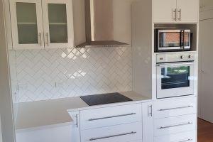 New reconfigured kitchen with tiled splashback and pantry in behind kitchen whangarei